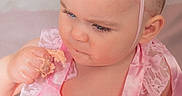 Bonnie-Rae is registered to the contest to win money with this photo: baby, child, pink_dress, birthday_crown, cake, one_year_old, face, hand, blue_eyes, lace, tutu, celebration, cute, portrait, indoor, skin, headband, serious_expression, frosting, sitting