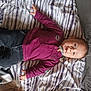 Loé participe au concours pour gagner de l'argent avec cette photo : baby, bed, blanket, casual_clothing, child, cozy, cute, dark_pants, expression, eyes, face, indoor, infant, lying_down, person, purple_shirt, small_hands, soft_texture, striped_bedspread, young