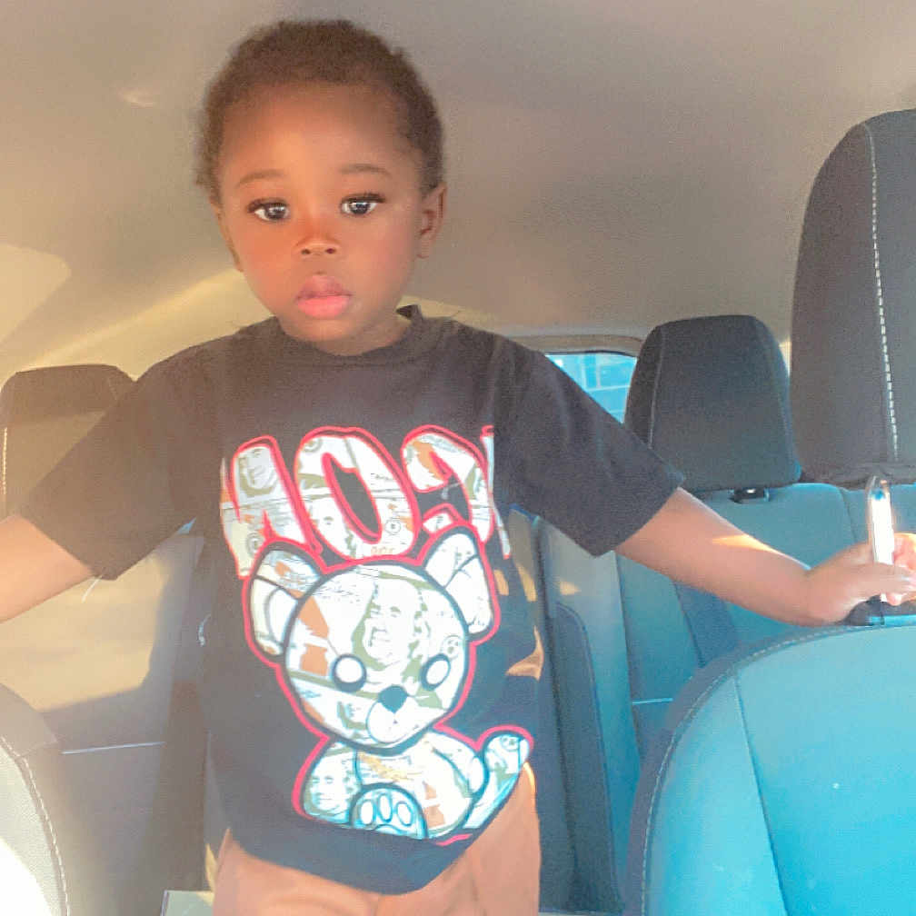 Jahsir is registered to the contest to win money with this photo: car_interior, casual, child, clothing, cute, face, hand, head, indoors, pants, person, portrait, seat, seatback, standing, sunlight, transportation, tshirt, window, young