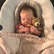 Noelle is registered to the contest to win money with this photo: baby, newborn, sleeping, teddy_bear, stuffed_animal, blanket, baby_seat, infant, cute, cozy, hands, hair, soft_toy, portrait, indoor, sleep, nursery, fabric, closeup, peaceful