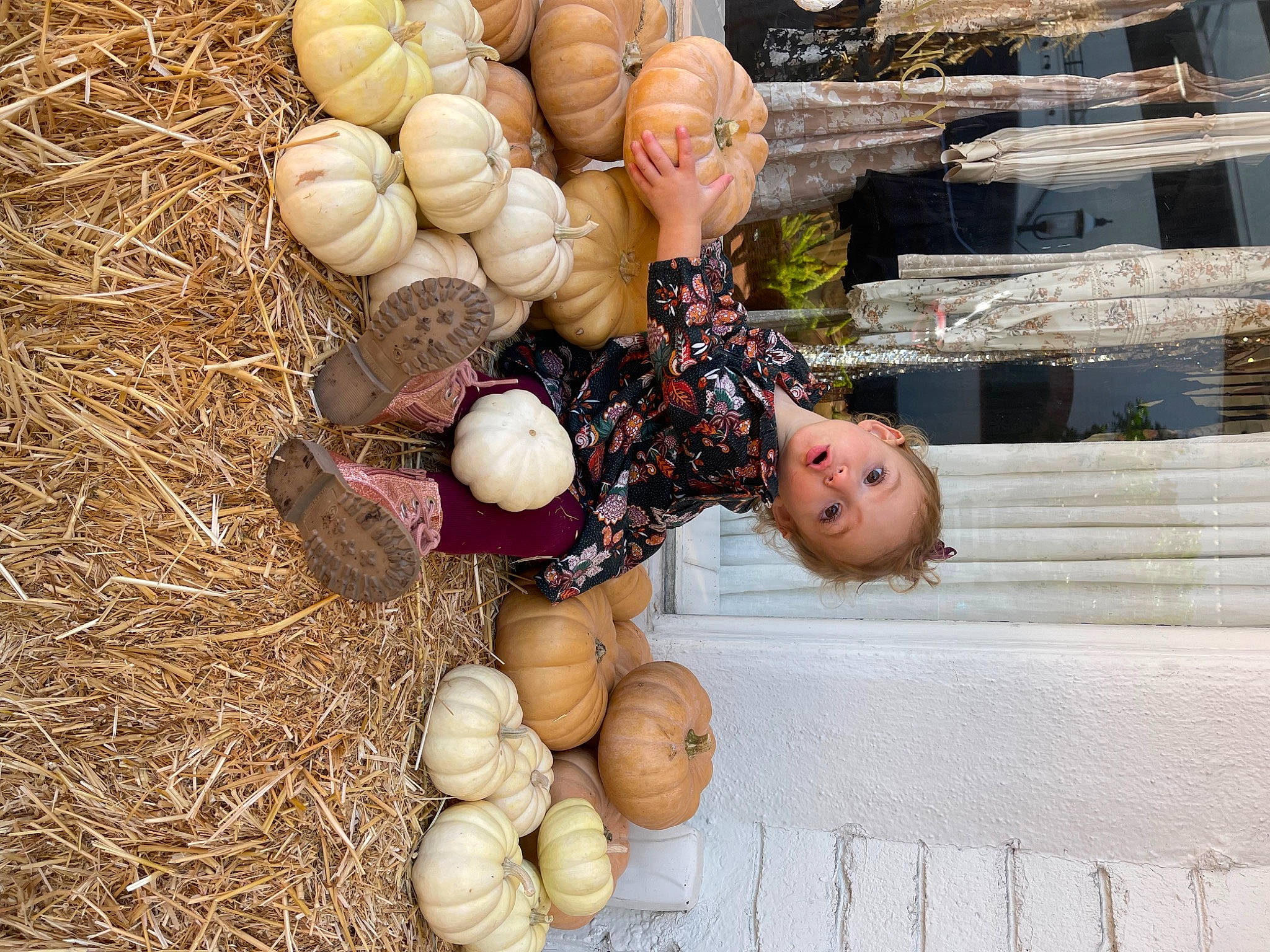 Ainsley is registered to the contest to win money with this photo: doll, egg, event, food, fruit, gourd, grass, happy, local_food, natural_foods, people_in_nature, person, plant, produce, pumpkin, soil, surprise, toy, vegetable, winter_squash
