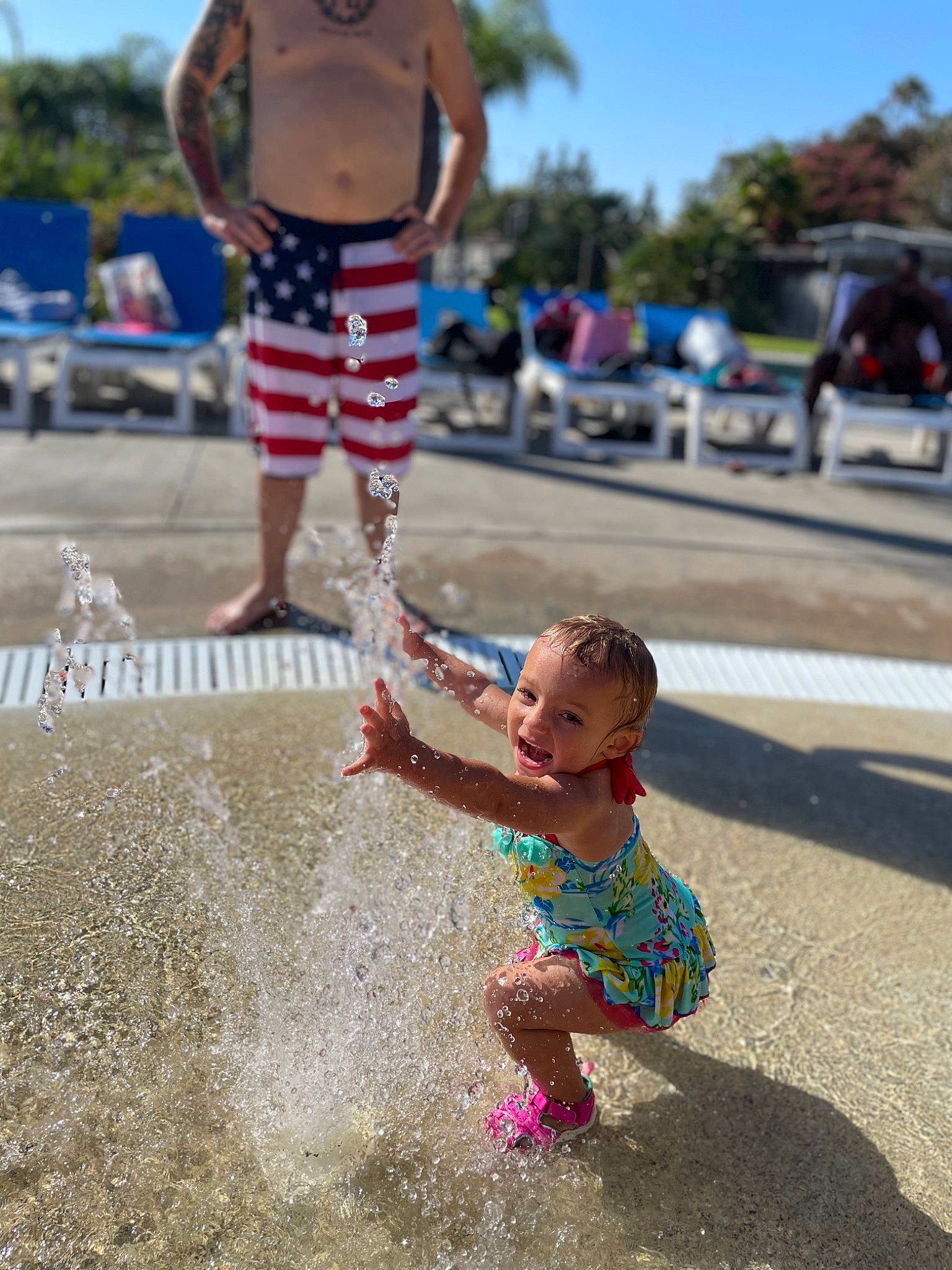 Ainsley is registered to the contest to win money with this photo: beach, blue, daytime, flag_of_the_united_states, fun, gesture, happy, human, leg, leisure, people, people_on_beach, person, photograph, public_space, sky, summer, toddler, tree, water