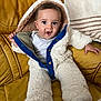 Aiden participe au concours pour gagner de l'argent avec cette photo : baby, child, onesie, fluffy_clothing, blue_trim, yellow_couch, leather, indoor, happy_expression, surprised, seated, person, infant, casual, warm_clothing, cozy, face, hands, hood, portrait