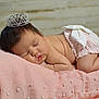 Anari joined the competition — help win amazing prizes! baby, sleeping, crown, pink_blanket, pearls, miniature_bed, infant, cute, soft_texture, peaceful, face, skin, hair, child, resting, adorable, toddler, white_bed, indoor, portrait