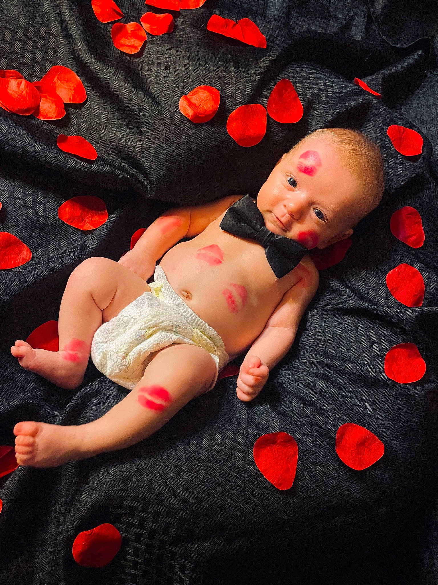 Tristan is registered to the contest to win money with this photo: baby, baby_toddler_clothing, black, comfort, eye, finger, flash_photography, foot, hand, human_body, human_leg, knee, leg, orange, pattern, person, pink, red, stomach, thigh
