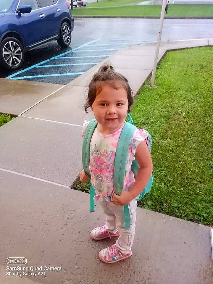 Elizabeth is registered to the contest to win money with this photo: alloy_wheel, asphalt, automotive_exterior, automotive_tire, car, grass, happy, joy, leisure, motor_vehicle, person, personal_luxury_car, rim, sandal, sidewalk, snapshot, tire, toddler, vehicle, vehicle_door