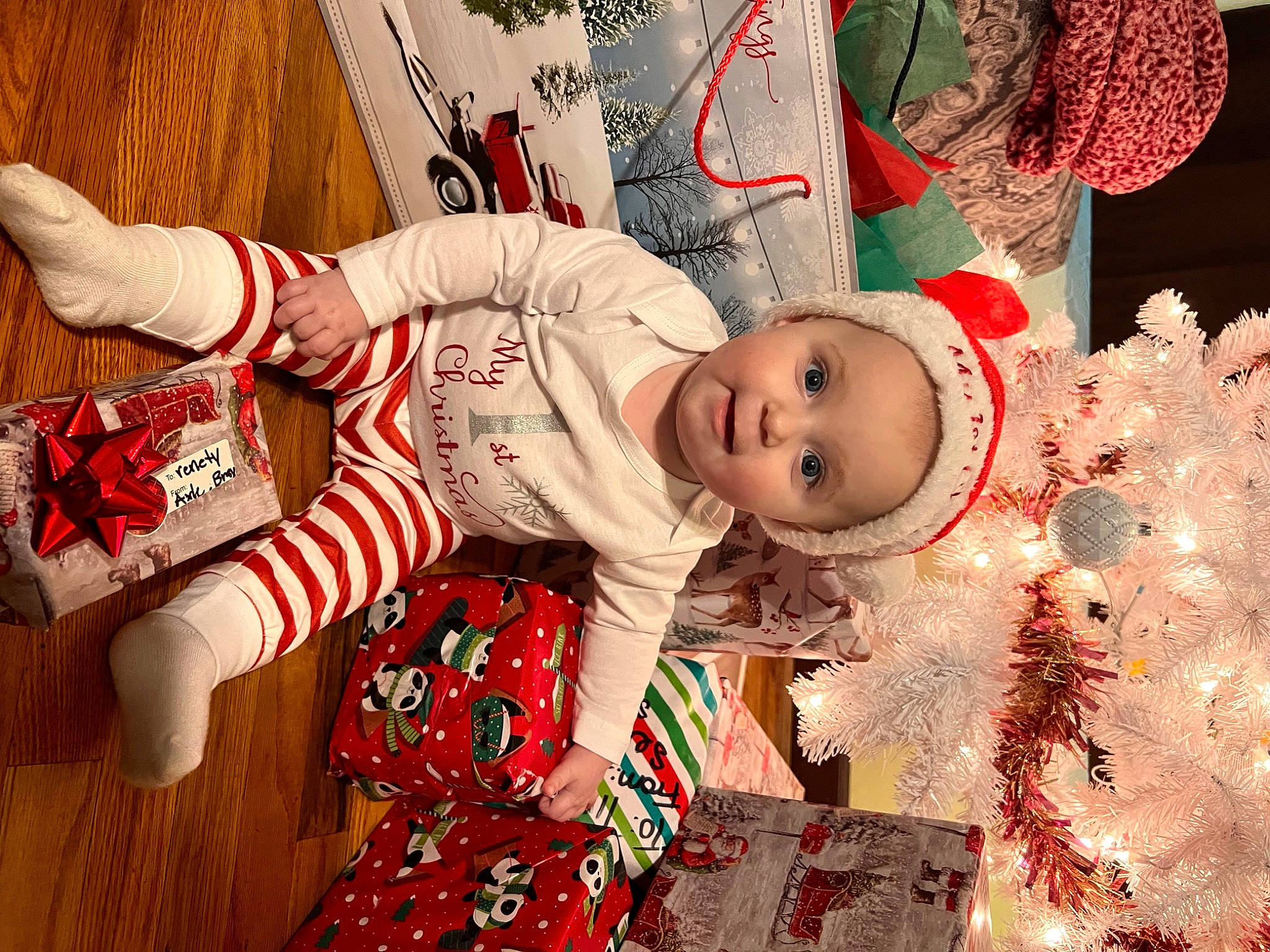 Serenity is registered to the contest to win money with this photo: baby, baby_toddler_clothing, carmine, child, christmas, christmas_eve, christmas_ornament, event, eye, happy, holiday, pajamas, pattern, person, red, room, sleeve, textile, toddler, tradition