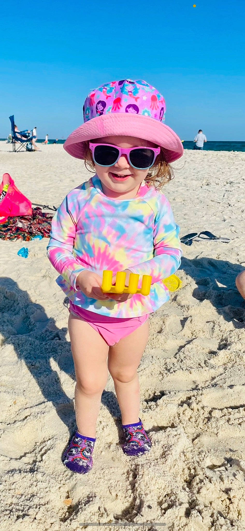 Maci joined the competition — help win amazing prizes! baby_toddler_clothing, beach, body_of_water, cool, eyewear, fun, glasses, goggles, happy, hat, head, headwear, light, people_on_beach, person, photograph, pink, sleeve, sunglasses, travel