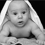 Pooty is registered to the contest to win money with this photo: baby, towel, black_and_white, infant, portrait, curious, face, skin, eyes, hands, lying_down, texture, closeup, expression, cute, child, newborn, soft_light, monochrome, background
