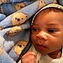 Hezekiah is registered to the contest to win money with this photo: baby, blanket, blue_blanket, teddy_bear_pattern, infant, face, close_up, soft_texture, cute, newborn, child, sleepwear, resting, indoors, portrait, small_hand, warm, comfort, peaceful, skin