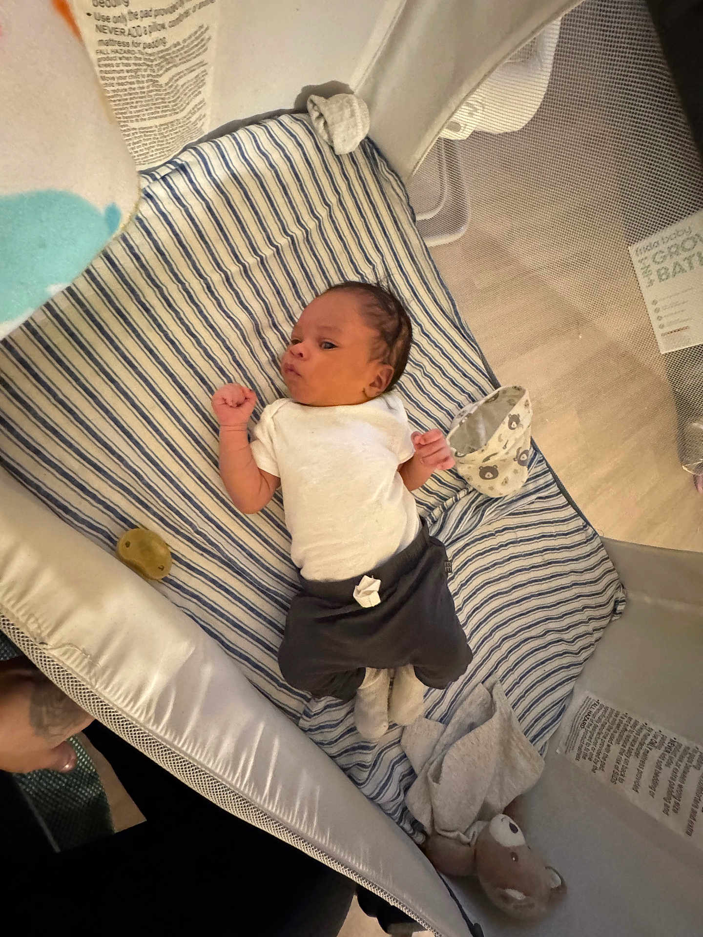 Hezekiah joined the competition — help win amazing prizes! baby, infant, playpen, blanket, plush_toy, clothing, sleepwear, face, newborn, person, baby_garment, soft_toy, striped_blanket, indoor, laying_down, cute, young_child, baby_accessory, footwear, resting