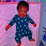 Xamira is registered to the contest to win money with this photo: baby, infant, pajamas, blanket, toy, stuffed_animal, crib, colorful, indoors, sleepwear, child, face, lying_down, soft_texture, bedtime, decor, clothing, cute, portrait, room