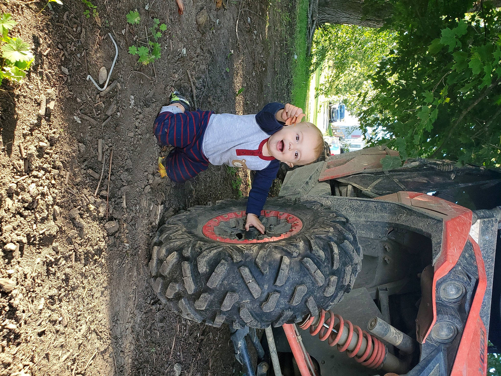 Landon is registered to the contest to win money with this photo: auto_part, automotive_tire, automotive_wheel_system, person, tire, tree, wheel