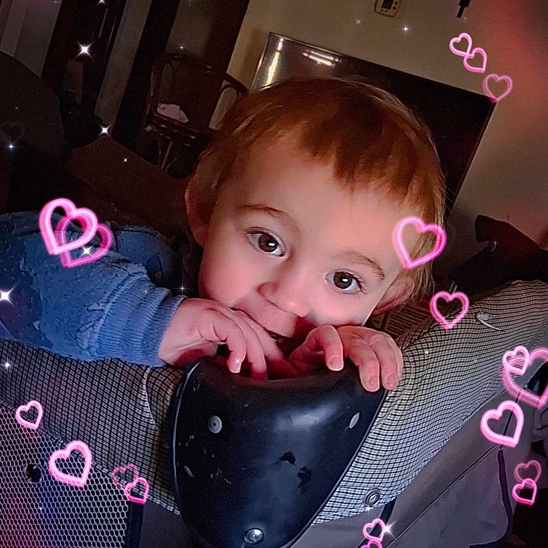 Leonidas joined the competition — help win amazing prizes! big_eyes, biting, blue_sweater, child, crucifix, cute, face, furniture, hands, hearts_overlay, indoor, living_room, picture_frame, playful, playpen, portrait, sparkles, teething, television, toddler