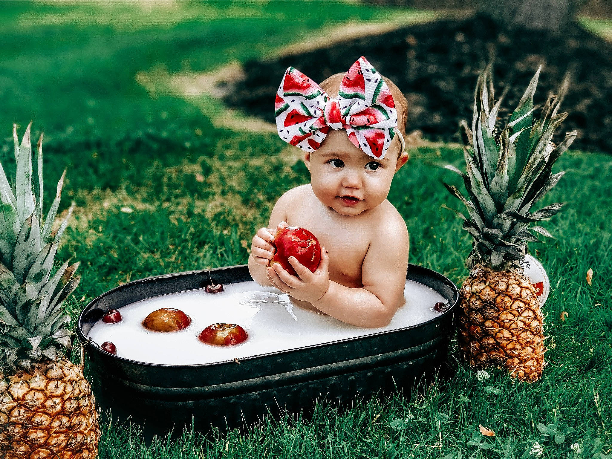 Rae joined the competition — help win amazing prizes! baby, child, event, facial_expression, flowerpot, fruit, grass, grass_family, happy, headpiece, headwear, lawn, leaf, ornament, people_in_nature, person, pineapple, plant, sitting, summer