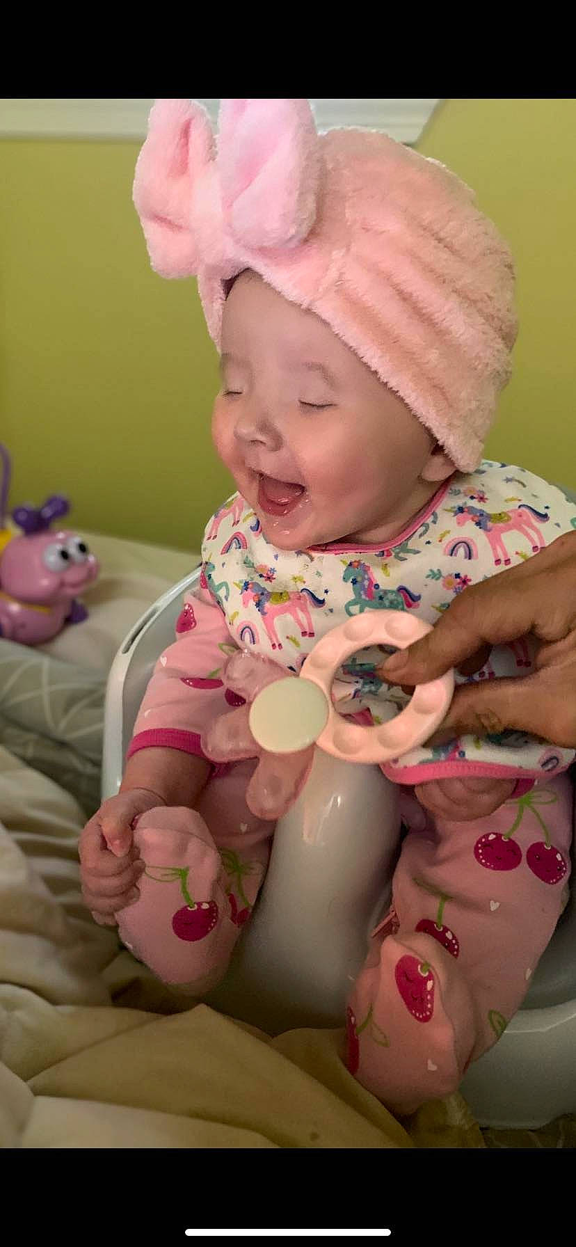 Jocelyn is registered to the contest to win money with this photo: arm, baby, baby_toddler_clothing, cap, cheek, child, face, facial_expression, finger, hand, happy, headwear, mouth, organ, person, pink, skin, sleeve, smile, textile