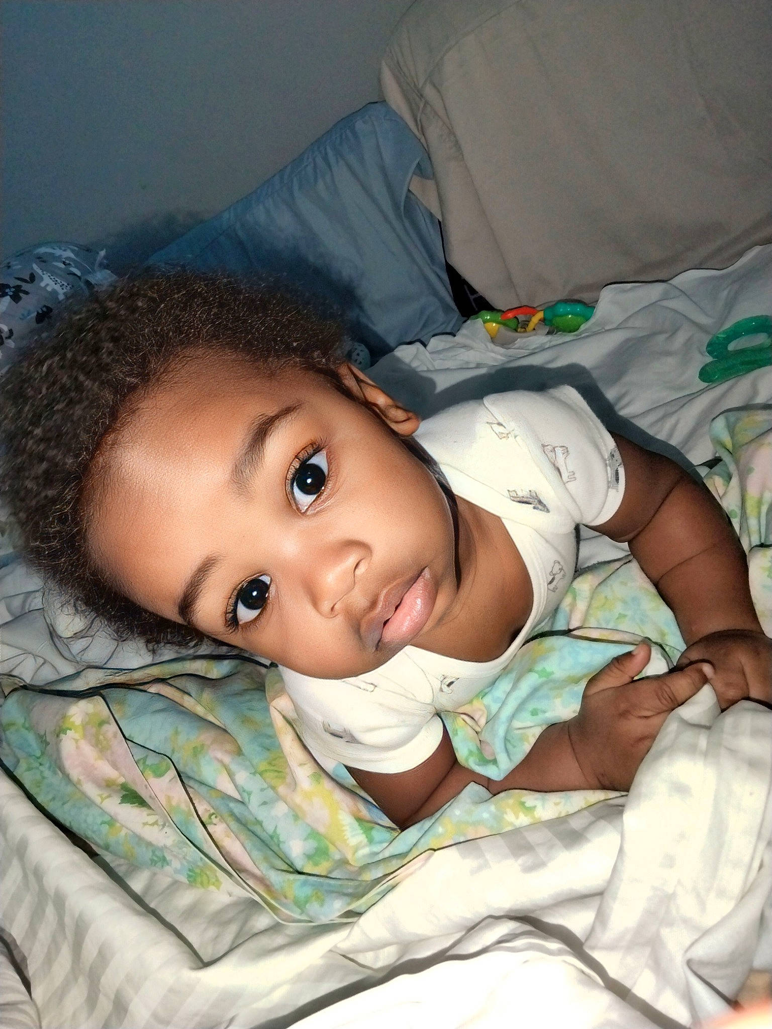 Chance is registered to the contest to win money with this photo: baby, baby_toddler_clothing, cheek, child, comfort, eye, eyelash, flash_photography, human_body, linens, lip, mouth, person, portrait_photography, room, sitting, skin, smile, toddler