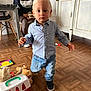 Johan a rejoint le concours — aidez-le/la à gagner de superbes lots ! adult, cabinet, chair, child, curly_hair, cute, floor, furniture, home, indoor, jeans, person, play, shirt, shoe, smile, toddler, toy, walking, wood_floor