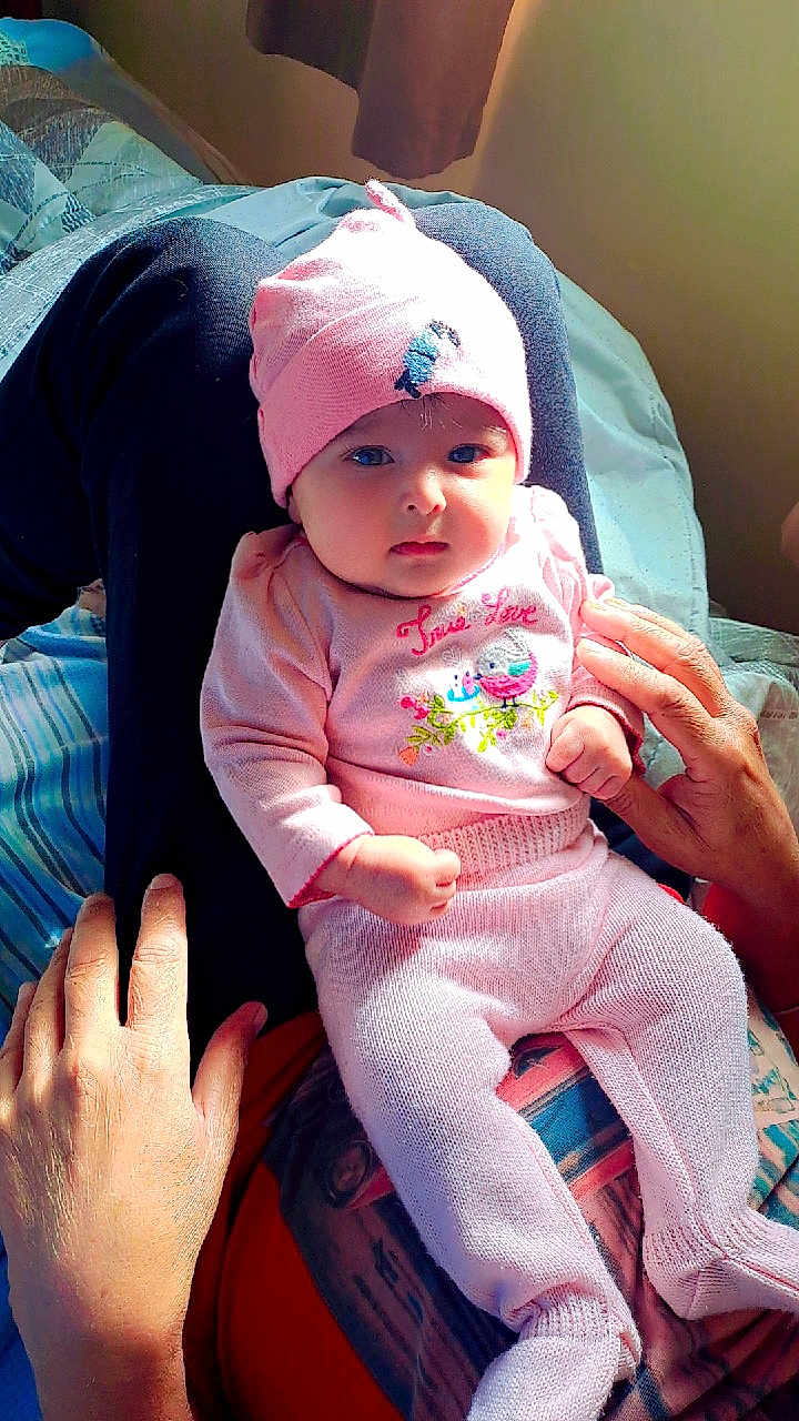 Mehreen joined the competition — help win amazing prizes! baby, blanket, child, closeup, cozy, cute, expression, hands, hat, human, indoor, infant, knitted, lap, person, pink_clothing, portrait, sitting, soft_lighting, warm
