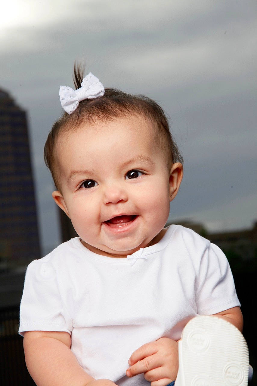Kira is registered to the contest to win money with this photo: baby, baby_toddler_clothing, cheek, chin, eye, eyelash, face, flash_photography, happy, head, headband, headpiece, iris, joy, lip, person, pink, skin, sky, sleeve