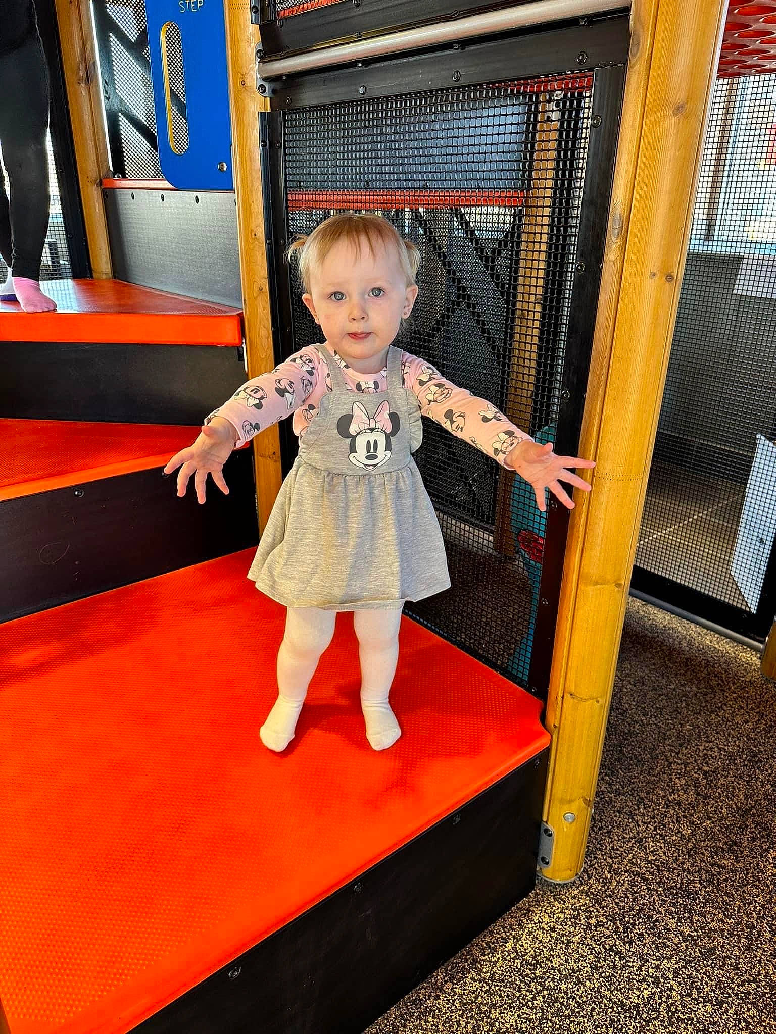 Eliza is registered to the contest to win money with this photo: baby_toddler_clothing, carpet, child, electric_blue, fashion_design, floor, flooring, foot, fun, happy, human_leg, leisure, pattern, person, play, recreation, room, sleeve, standing, toddler