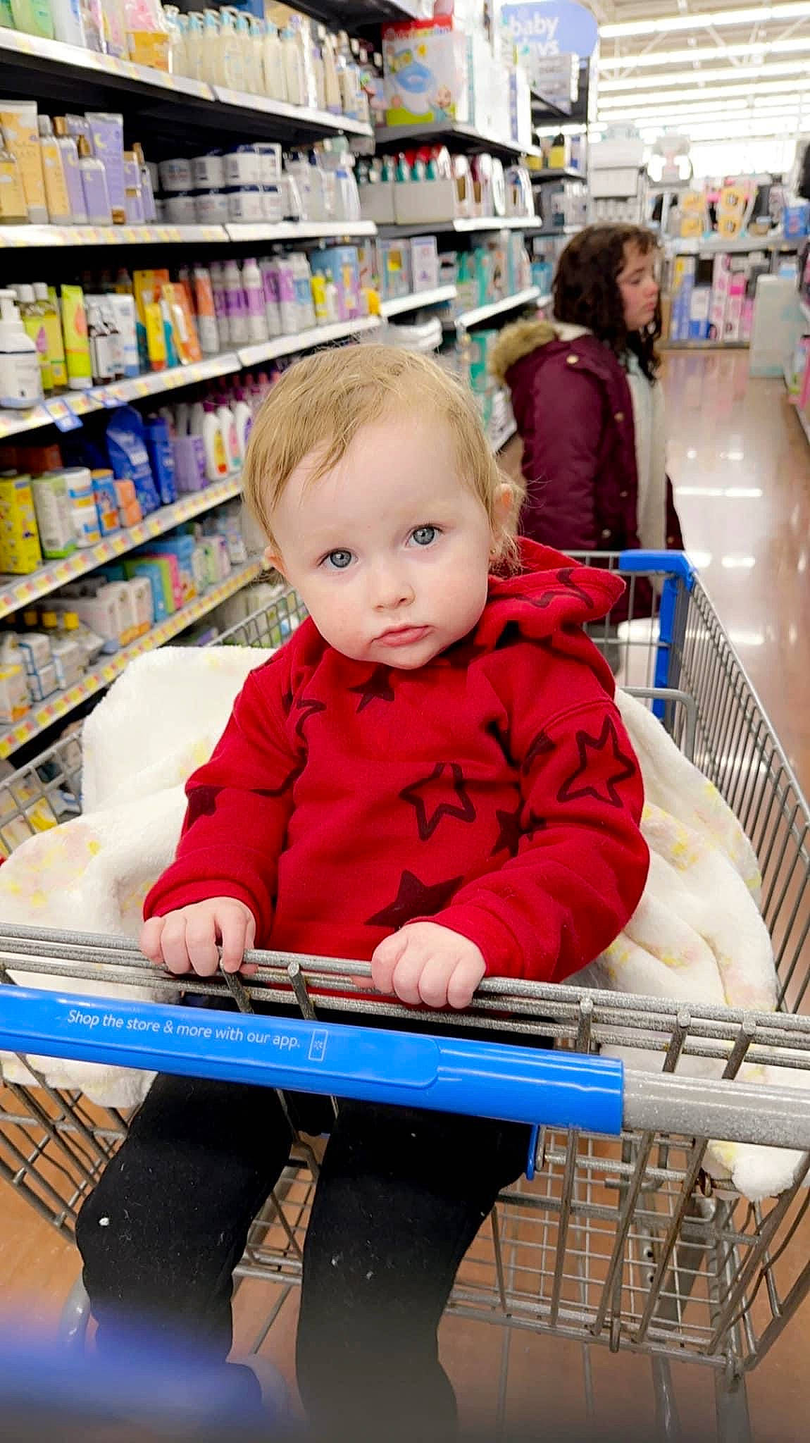Eliza is registered to the contest to win money with this photo: aisle, beauty, cart, child, convenience_store, customer, fun, grocery_store, person, photograph, product, publication, retail, service, shelf, shelving, shopping, shopping_cart, sitting, snapshot