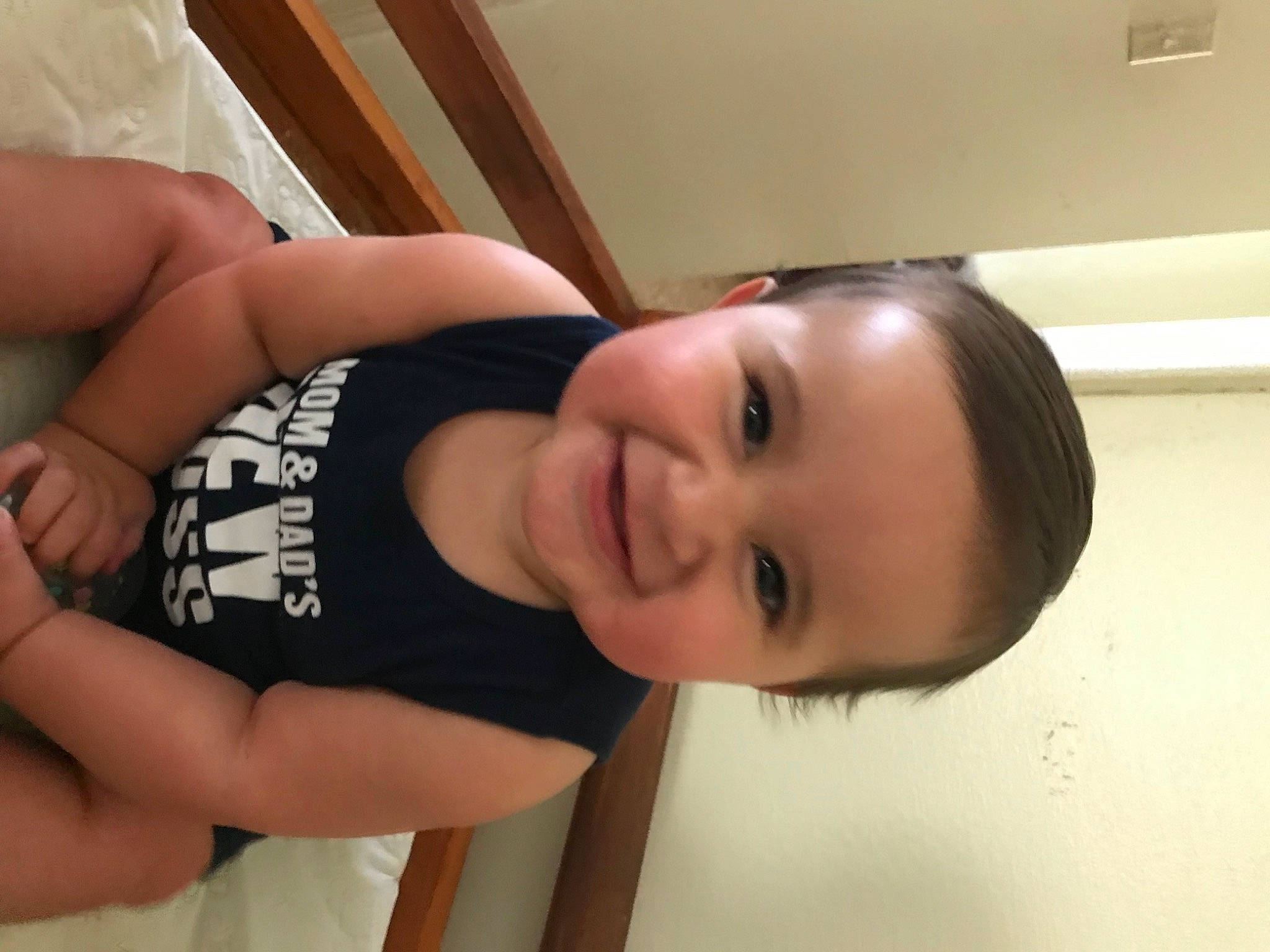 Devin is registered to the contest to win money with this photo: baby_toddler_clothing, black_hair, cheek, chest, elbow, eyelash, finger, gesture, happy, human_body, joy, leg, lip, mouth, neck, nose, person, skin, sleeve, smile