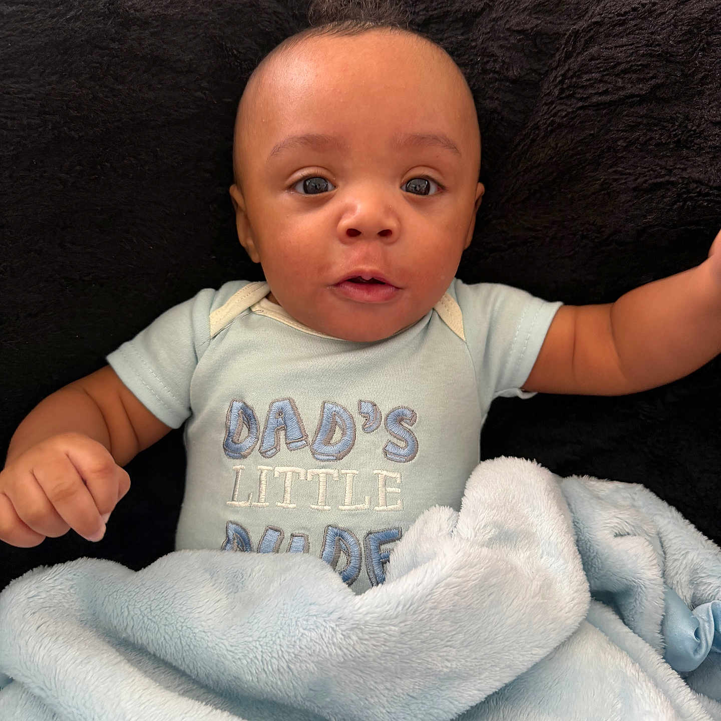 Kingsten Ingram joined the competition — help win amazing prizes! baby, baby_boy, black, blanket, blue, child, clothing, cushion, cute, expression, face, indoors, infant, newborn, onesie, person, portrait, snuggle, soft, wide_eyes