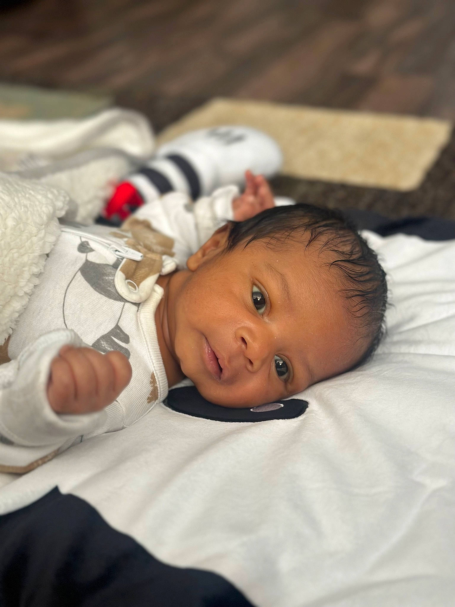 Leo is registered to the contest to win money with this photo: baby, baby_toddler_clothing, bedtime, cheek, child, comfort, flooring, grass, happy, linens, person, portrait_photography, room, sitting, sleep, toddler, wood