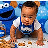 baby, child, infant, crawling, smiling, portrait, cookie_monster, cookies, cookie_jar, crumbs, blue_balloons, balloons, costume, bib, table, indoor, birthday, toys, food, close_up