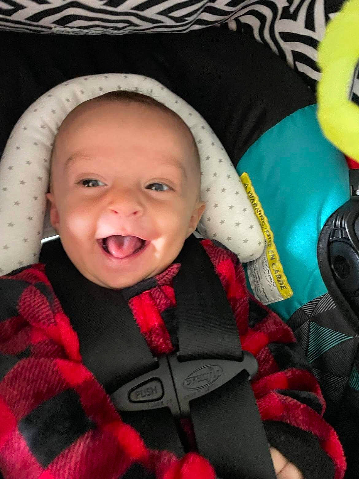 River is registered to the contest to win money with this photo: baby, baby_carriage, baby_toddler_clothing, cheek, comfort, cool, fun, happy, headgear, mouth, nose, outerwear, person, pink, seat_belt, skin, sleeve, smile, textile, toddler