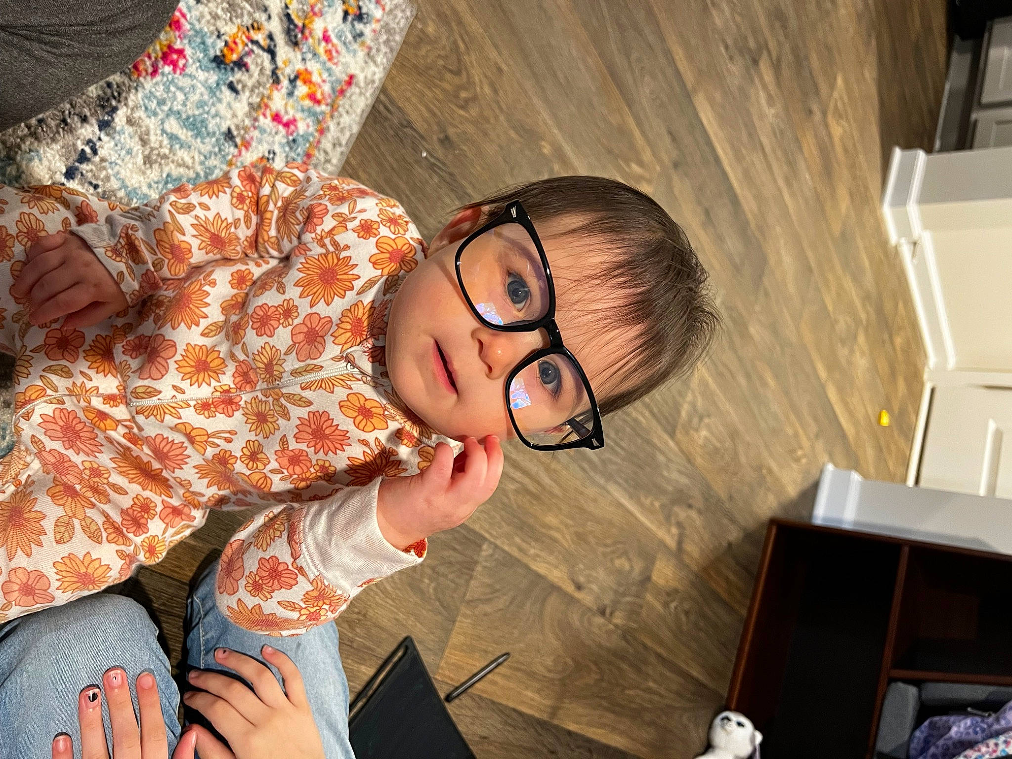 Alice is registered to the contest to win money with this photo: black_hair, child, cool, eyewear, facial_expression, fashion_design, fun, glasses, hairstyle, happy, human_leg, leisure, mouth, pattern, person, room, sitting, skin, thigh, vision_care