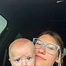 Michael joined the competition — help win amazing prizes! baby, blue_shirt, car, clothing, expression, face, glasses, hair, head, indoor, infant, person, portrait, seat, seatbelt, selfie, skin, warning_label, window, woman