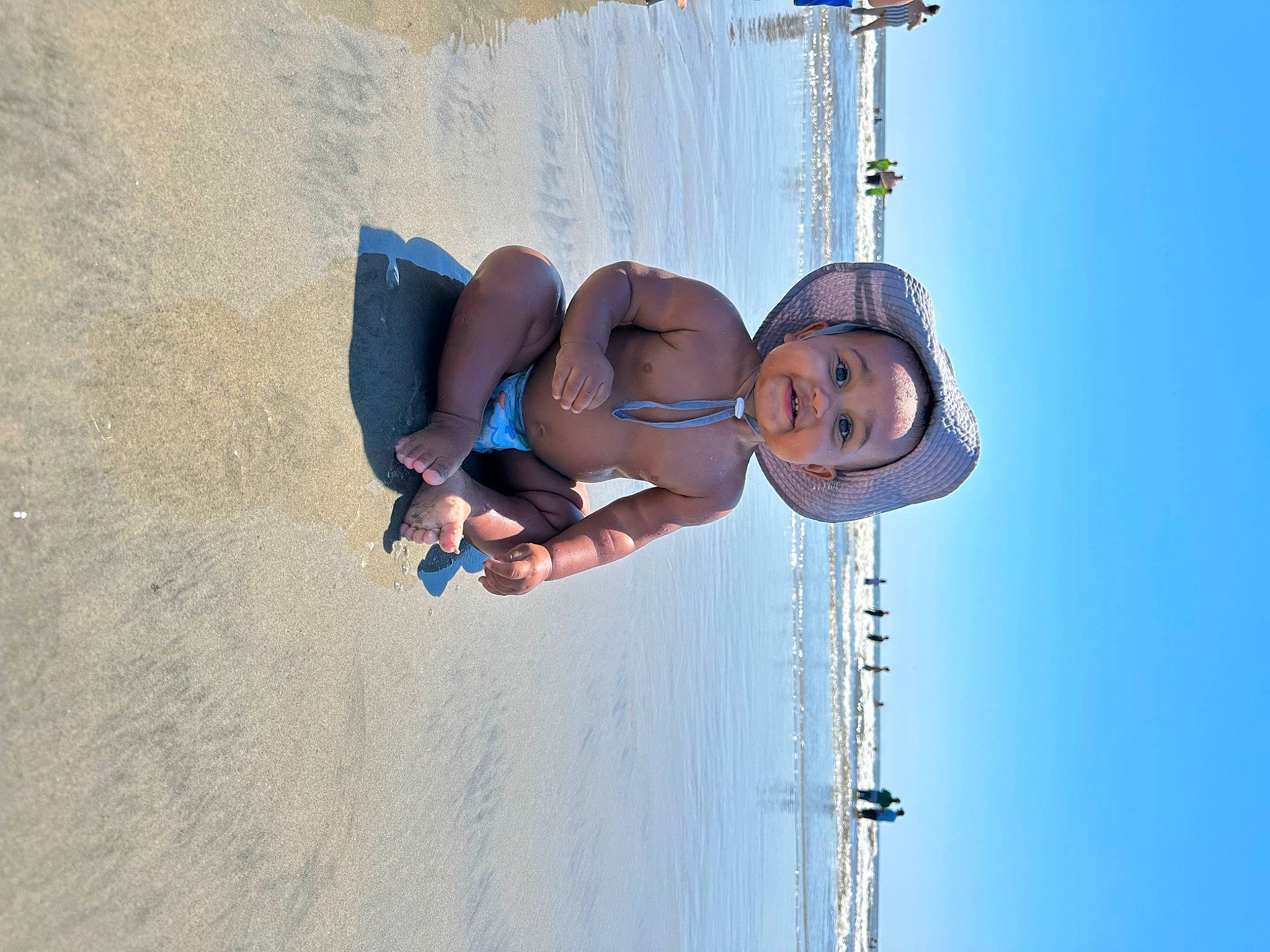 Cairo is registered to the contest to win money with this photo: adventure, azure, beach, elbow, electric_blue, fun, happy, landscape, leisure, ocean, outdoor_play_equipment, person, recreation, shorts, sky, smile, toddler, travel, water