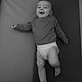 Léo participe au concours pour gagner de l'argent avec cette photo : baby, infant, smiling, lying_down, diaper, sweater, happy, cute, child, black_and_white, portrait, young, one_person, indoors, soft_surface, legs, feet, face, expression, joy