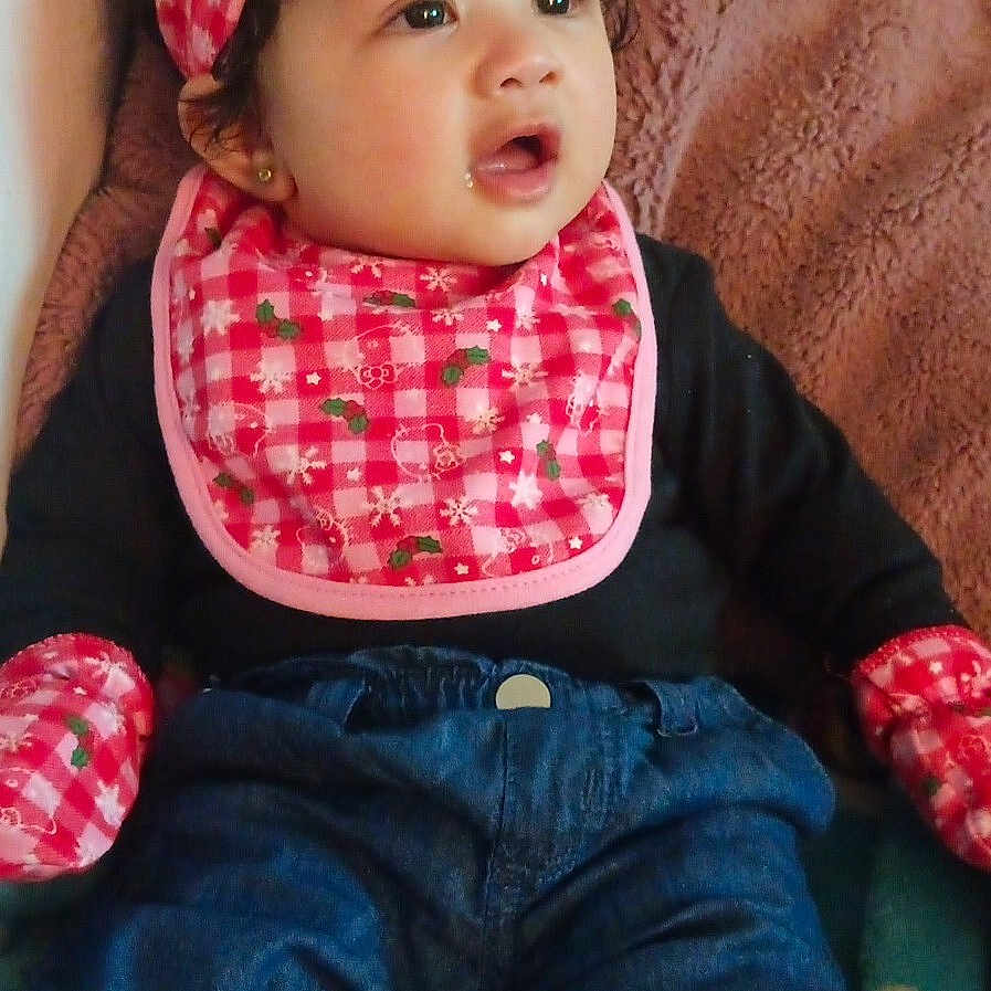 A'Doree joined the competition — help win amazing prizes! baby, bib, blanket, child, clothing, curious, cute, expression, face, headband, indoors, infant, jeans, mittens, person, portrait, sitting, soft_texture, warm_clothing, young_child