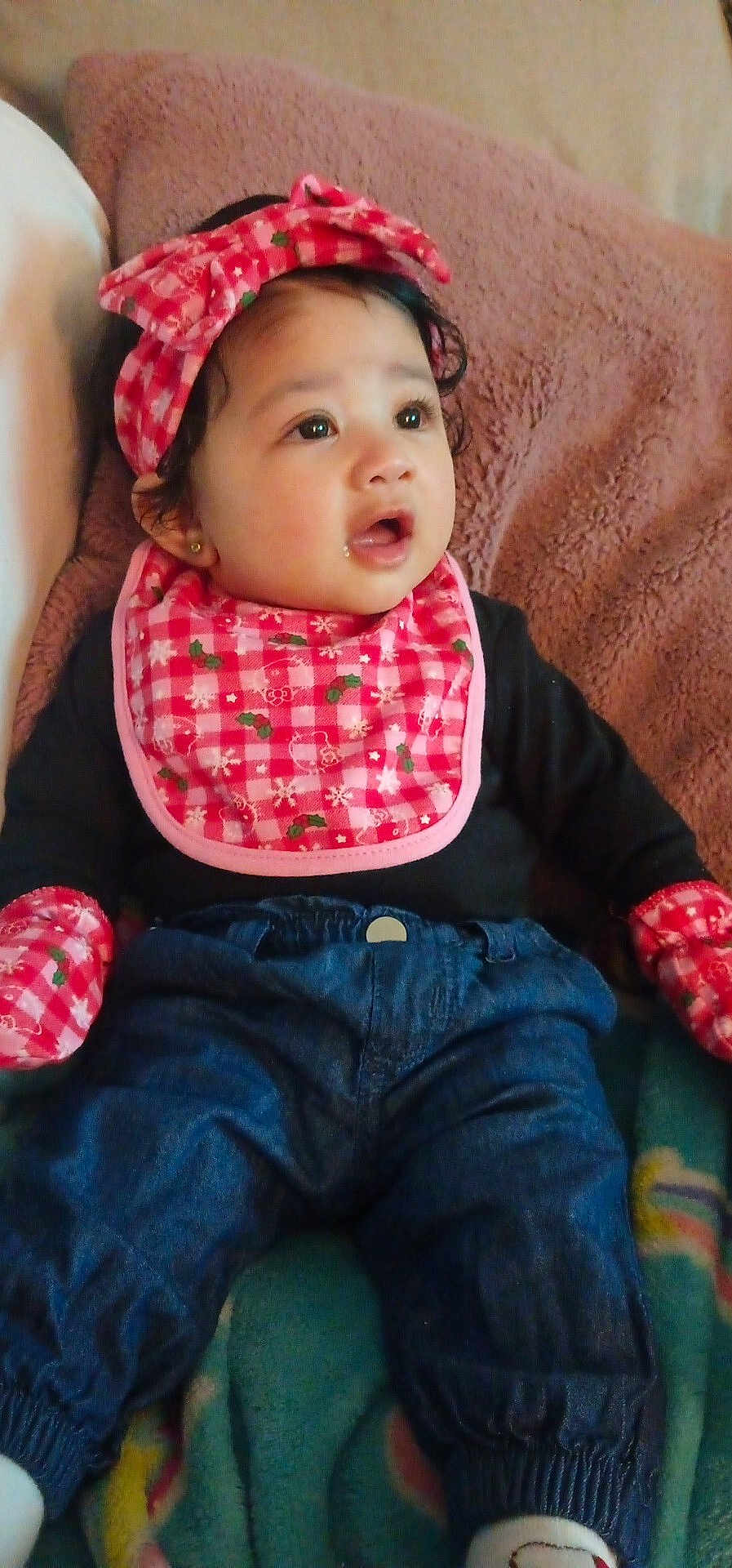 A'Doree joined the competition — help win amazing prizes! baby, child, infant, bib, headband, clothing, jeans, mittens, blanket, sitting, curious, indoors, cute, portrait, young_child, person, soft_texture, warm_clothing, face, expression