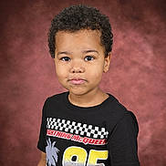 Jeremy joined the competition — help win amazing prizes! child, portrait, curly_hair, tshirt, lightning_mcqueen, black_tshirt, studio_background, smile, young_boy, casual_clothing, colorful, red, yellow, black, eyes, face, short_sleeves, standing, indoor, photography