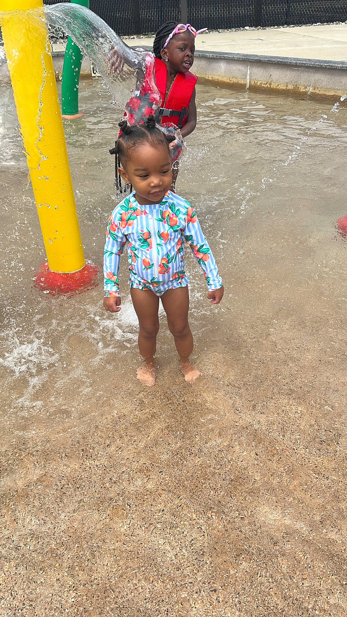 Malani is registered to the contest to win money with this photo: asphalt, barefoot, child, city, concrete, flooring, foot, fun, grass, human_leg, leisure, person, play, recreation, road, road_surface, sand, sidewalk, soil, toddler