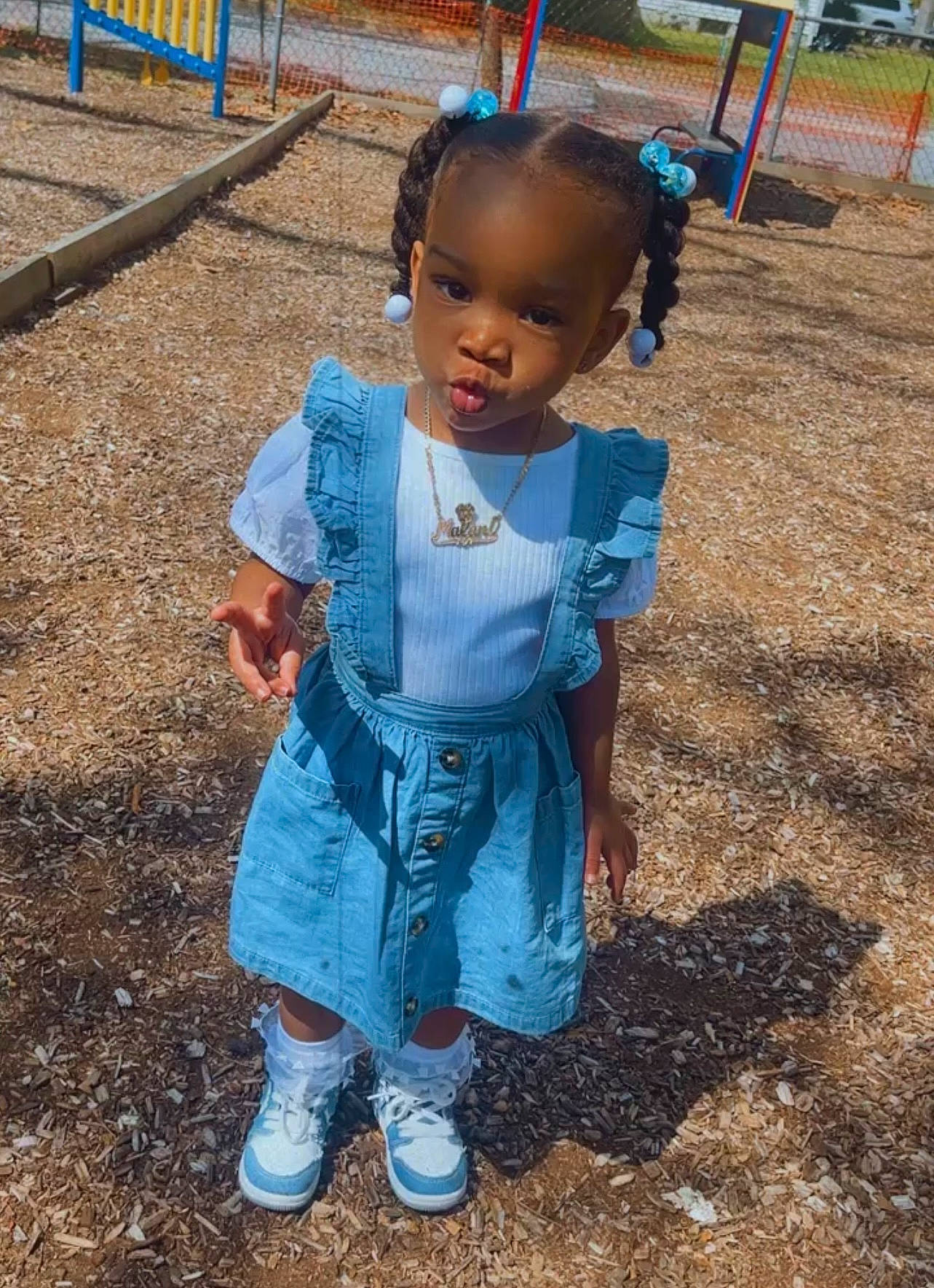 Malani is registered to the contest to win money with this photo: baby_toddler_clothing, boot, child, city, denim, electric_blue, fun, grass, happy, leisure, outdoor_play_equipment, person, play, playground, sitting, sleeve, smile, soil, toddler