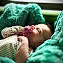 Oakley is registered to the contest to win money with this photo: baby, infant, pacifier, blanket, teal, sleepwear, newborn, face, skin, hand, soft, cozy, resting, indoors, portrait, cute, child, peaceful, young, comfort