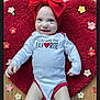 Oakley is registered to the contest to win money with this photo: adorable, baby, child, cute, felt_flowers, floor, happy, headband, heart_shaped_rug, indoors, infant, lying_down, onesie, playful, portrait, red_bow, red_trim, smiling, toddler, white_clothing