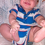 Miles is registered to the contest to win money with this photo: baby, bodypart, chair, clothing, cushion, face, finger, furniture, hand, happy, head, homedecor, laughing, pants, person, photography, portrait, shorts, smile, t_shirt