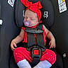 baby, infant, sleeping, car_seat, safety_harness, red_outfit, polka_dots, headband, bow, pacifier, portrait, indoors, vehicle, seated, closed_eyes, peaceful, child, textile, socks,  안전