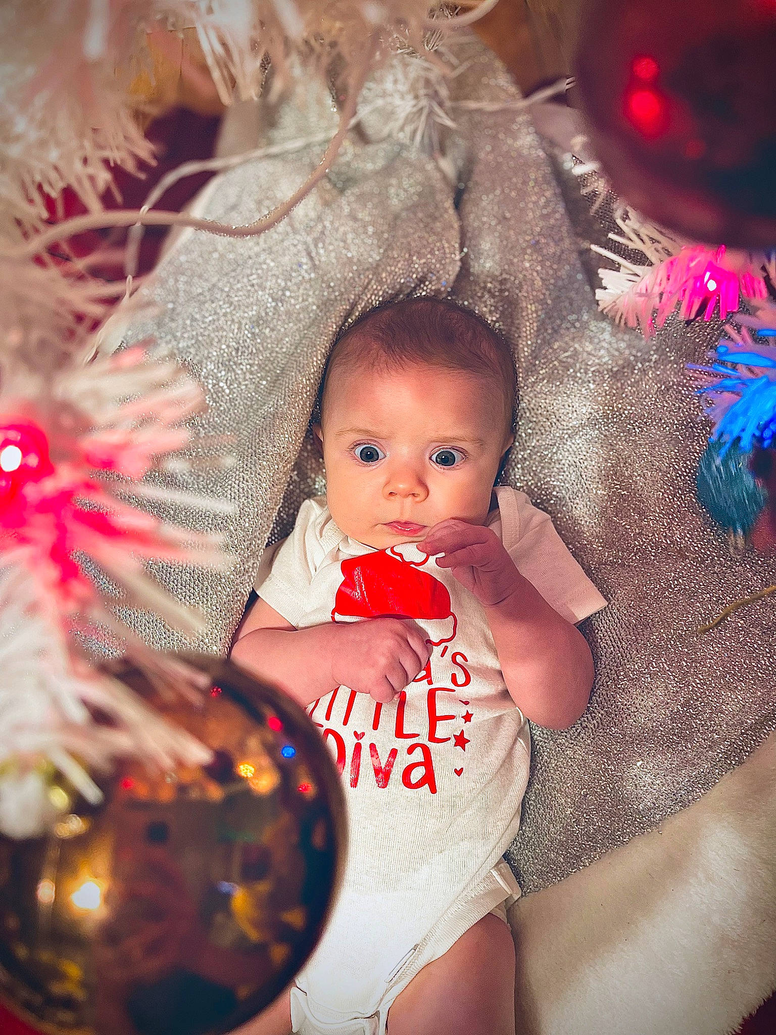 Everleigh is registered to the contest to win money with this photo: baby, baby_toddler_clothing, child, christmas, christmas_decoration, christmas_eve, christmas_ornament, christmas_tree, conifer, event, flash_photography, fun, happy, holiday, holiday_ornament, human, ornament, person, toddler, toy