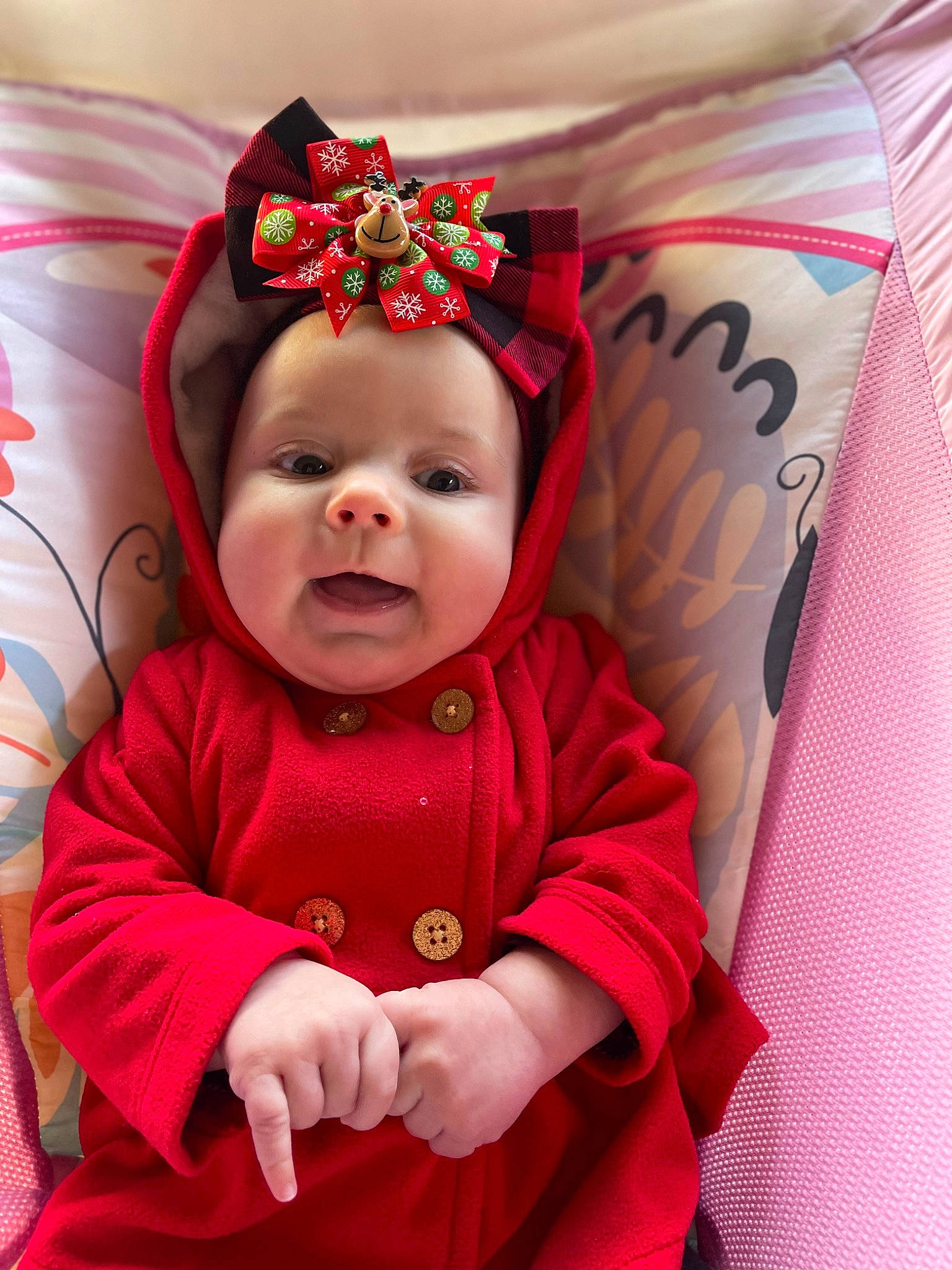 Everleigh is registered to the contest to win money with this photo: baby, baby_toddler_clothing, cap, child, christmas, christmas_eve, comfort, costume_hat, event, fictional_character, fun, happy, hat, headwear, holiday, linens, magenta, person, pink, sleeve