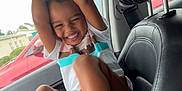 Amari joined the competition — help win amazing prizes! child, smiling, car, interior, sneakers, window, handle, seat, headrest, laughing, clothing, shorts, tshirt, seatbelt, door, glass, person, happy, playful, kid