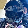 kitten, cat, animal, helmet, motorcycle, rider, person, pet, cuddling, holding, calico, fur, pink_sweater, jacket, visor, outdoor, portrait, reflection, vehicle, family