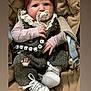 baby, infant, pacifier, headband, car_seat, clothing, shoes, beads, hand, face, cute, soft, warm, child, portrait, sitting, indoor, cozy, cute_baby, accessory