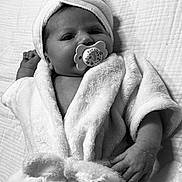 Maïlyna participe au concours pour gagner de l'argent avec cette photo : baby, infant, pacifier, bathrobe, towel, blanket, soft_texture, black_and_white, portrait, cute, child, newborn, face, hand, lying_down, wrapped, cozy, sleepwear, indoors, closeup
